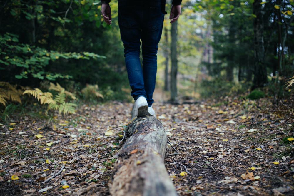 Person balancing on a downed log