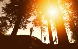 Family cheering on a sunset hike