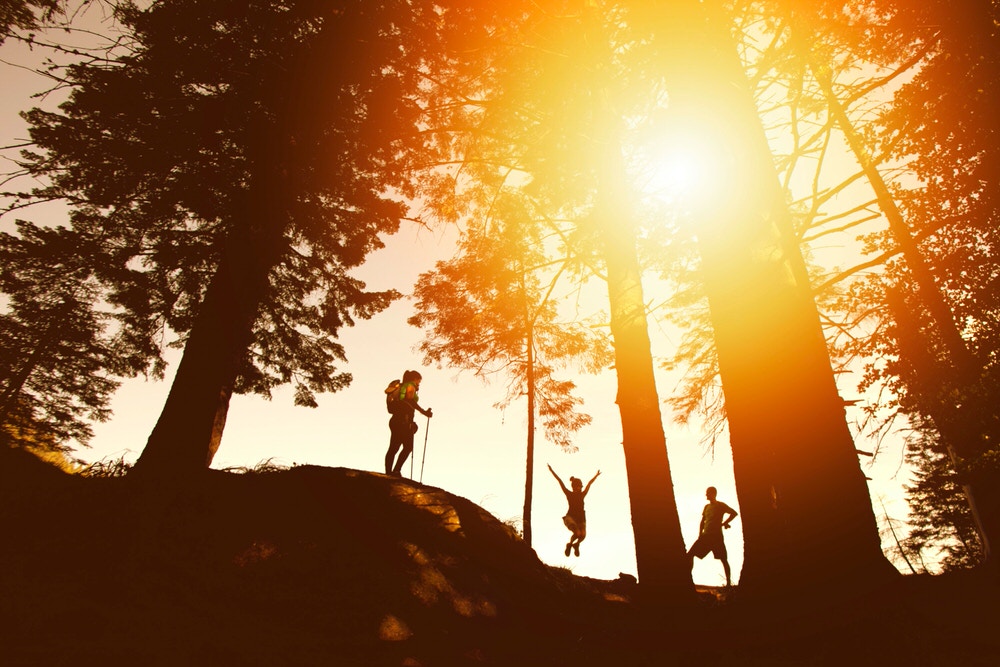 Family cheering on a sunset hike