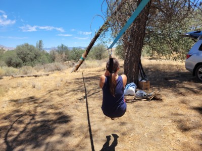 Adult ziplining on slackline