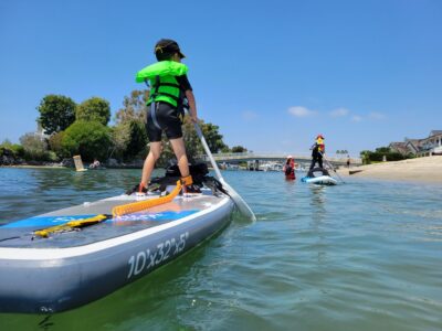 Kids paddle boarding and having fun